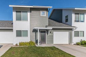 Minot apartment for rent - a gray and with a driveway and a garage door