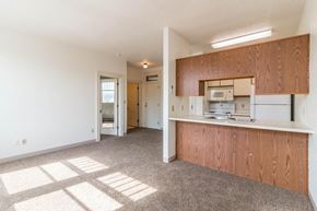 Devils Lake apartment for rent - an empty kitchen with wood cabinets and a white counter top