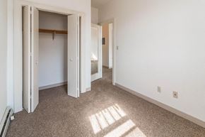 Devils Lake apartment for rent - an empty room with a hallway to a bedroom and a closet