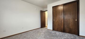 Devils Lake apartment for rent - a bedroom with a closet and a door to a hallway