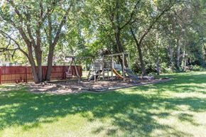 Princeton apartment for rent - a playground in a yard with trees and a swing set