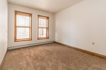 Devils Lake apartment for rent - the living room of a home with carpet and two windows