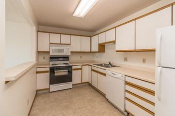 Bismarck apartment for rent - the preserve at ballantyne commons apartment kitchen with white cabinets and appliances