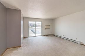 Bismarck apartment for rent - the living room of an empty apartment with a door to the balcony