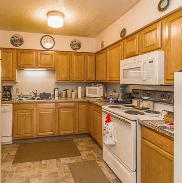 Dickinson apartment for rent - a kitchen with white appliances and wooden cabinets