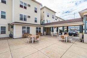 Dickinson apartment for rent - a patio with tables and chairs outside of a building