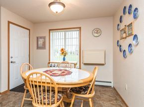 West Fargo townhouse for rent - a dining room with a table and chairs and a window