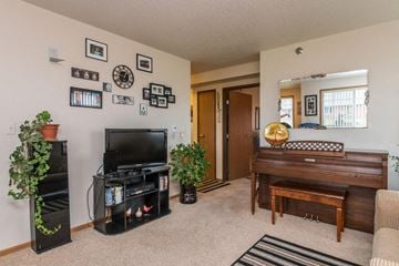 West Fargo townhouse for rent - a living room with a piano and a television