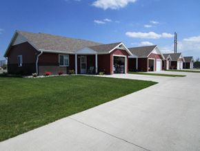 West Fargo townhouse for rent - a group of houses in a row with a sidewalk and grass