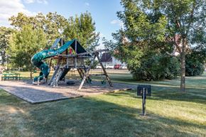 Little Falls apartment for rent - A playground with a green slide and a wooden structure.