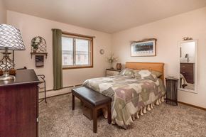 Monticello apartment for rent - a bedroom with a bed and a dresser and a window