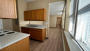Grafton apartment for rent - A kitchen with wooden cabinets and a white countertop.