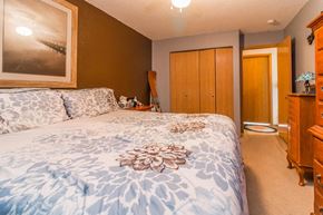 Faribault apartment for rent - a bedroom with a bed and a dresser and a bathroom