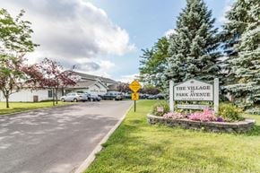 Faribault apartment for rent - the village park avenue entrance sign on the side of a road