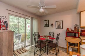 Faribault apartment for rent - a dining room with a table and chairs and a ceiling fan