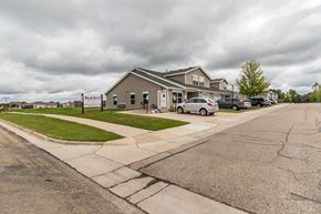 Owatonna townhouse for rent - the front of a building with cars parked in front of it