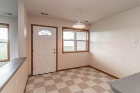 Owatonna townhouse for rent - the living room of a house with a checkered floor and a white door
