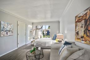 Los Angeles apartment for rent - A bedroom with a large bed and a painting on the wall.