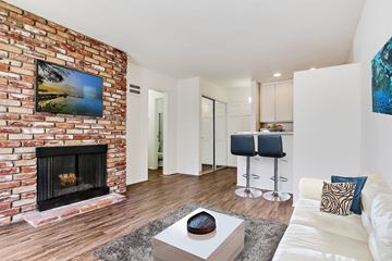 Los Angeles apartment for rent - A living room with a fireplace and a painting on the wall.