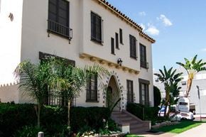 Los Angeles apartment for rent - A white house with a black balcony and a black railing.