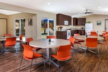 San Diego apartment for rent - a dining room with tables and chairs and a kitchen
