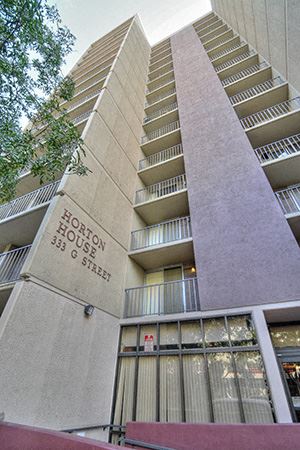 San Diego apartment for rent - a tall building with a sign on the side of it