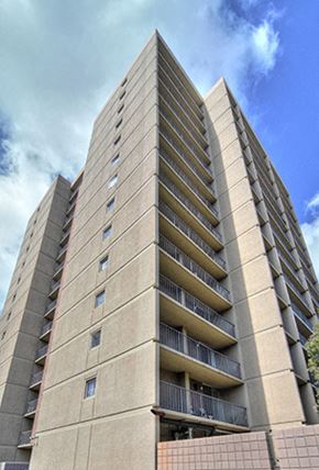 San Diego apartment for rent - a tall building with a blue sky in the background