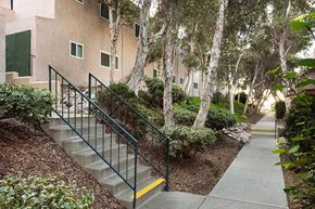 Spring Valley apartment for rent - a set of stairs in front of a building with trees