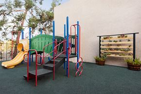 Spring Valley apartment for rent - a playground with a slide and a bench