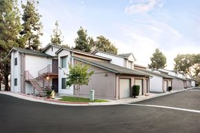 San Diego apartment for rent - a row of houses with stairs and a street in front