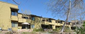 Poway apartment for rent - a row of houses with yellow siding and balconies