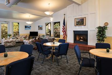 Poway apartment for rent - a living room with tables and chairs and a fireplace