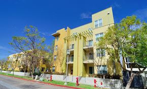 San Diego apartment for rent - a row of yellow apartment buildings on the side of a street