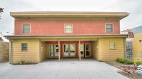 San Diego apartment for rent - the front of a yellow and red building with doors