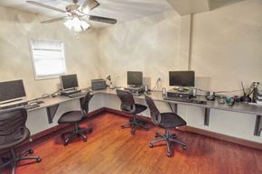 San Diego apartment for rent - a room with three desks with computers and a ceiling fan