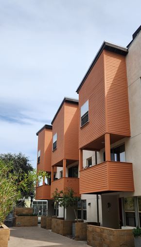 San Diego apartment for rent - A modern building with orange and white balconies.