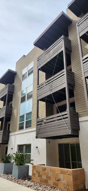 San Diego apartment for rent - A modern building with a balcony and a window.