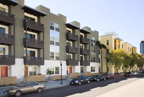 San Diego apartment for rent - A row of apartment buildings with cars parked in front.