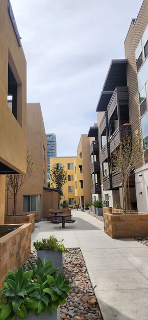 San Diego apartment for rent - A modern courtyard with a picnic table surrounded by buildings.
