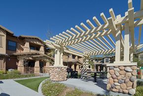 Poway apartment for rent - a covered patio with a picnic table in front of a building