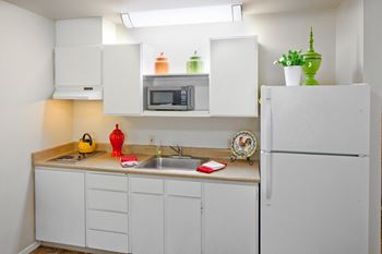 Kitchen with cook top, refrigerator, and sink