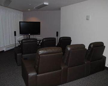 Sequim apartment for rent - a living room with leather chairs and a television