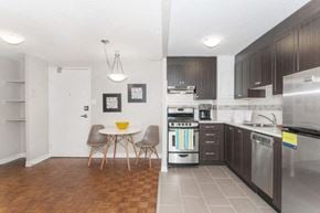 Ottawa apartment for rent - A kitchen with a table and chairs in the middle of the room.