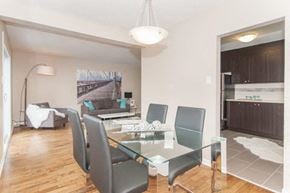 Ottawa apartment for rent - A modern dining room with a glass table and chairs.