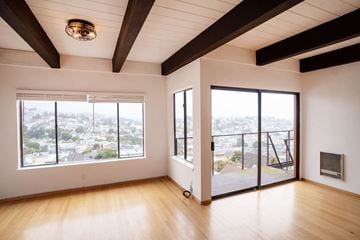 San Francisco apartment for rent - A large empty room with a view of the city.
