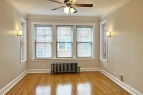 Oak Park apartment for rent - A room with a ceiling fan and a radiator on the floor.