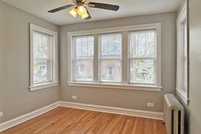 Oak Park apartment for rent - A room with a ceiling fan and three windows.