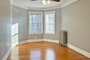 Oak Park apartment for rent - A room with a ceiling fan and a radiator on the floor.