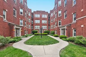 Oak Park apartment for rent - A courtyard surrounded by red brick buildings.