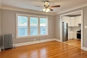 Oak Park apartment for rent - A room with a ceiling fan and a window with blinds.